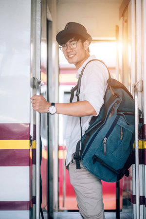 Asian man is traveler, he is waiting for their train. Outdoor adventure travel by train concept....