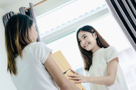 Young asian girl is freelancer with her private business at home office, working with laptop, coffee, online marketing, Customer order and packaging or packing.の写真素材