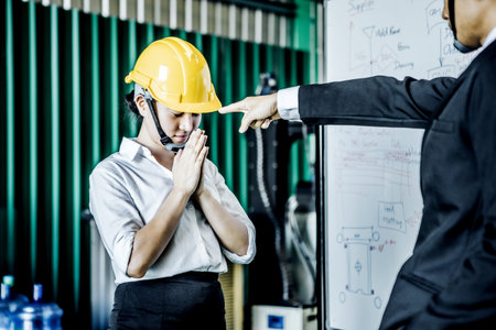 A young Asian office worker is sad and was severely criticized by her boss for her mistakes.