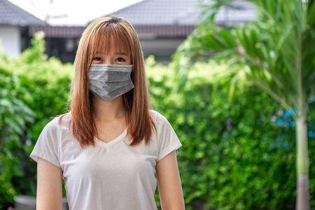 Asian teenage girls are wearing masks to protect themselves from dust and prevent the spread of coronavirus or covid-19 outbreaks to work from home.の写真素材