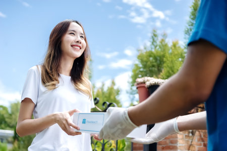 Medicine delivery man courier in mask and gloves with medical pills purchases during the prevention of coronovirus, Safety home and quarantine concept, Volunteer with Donation goods.の写真素材