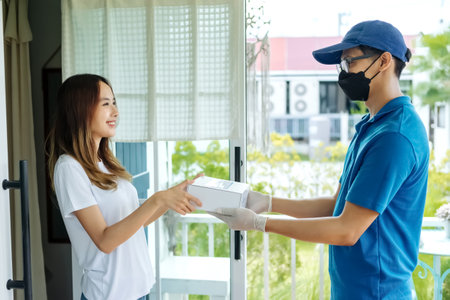 Medicine delivery man courier in mask and gloves with medical pills purchases during the prevention of coronovirus, Safety home and quarantine concept, Volunteer with Donation goods.の写真素材