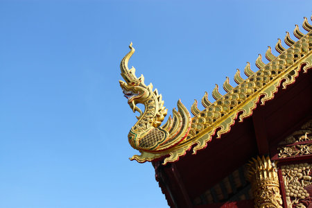 Gable apex in temple roof with blue sky background 