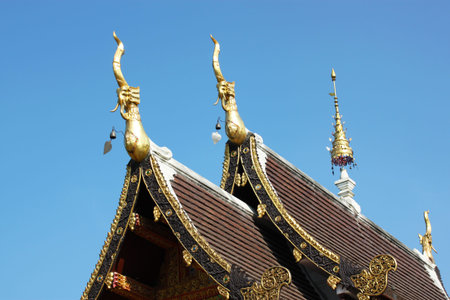 detail of ornately decorated temple roof in chaingmai, thailand 