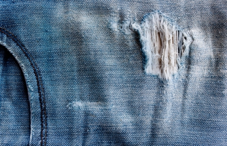 torn old blue jeans backgroundの写真素材