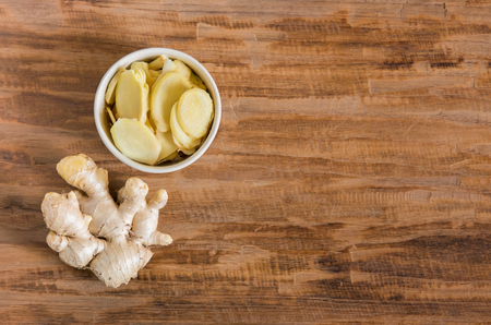 ginger on wood background with space for textの写真素材