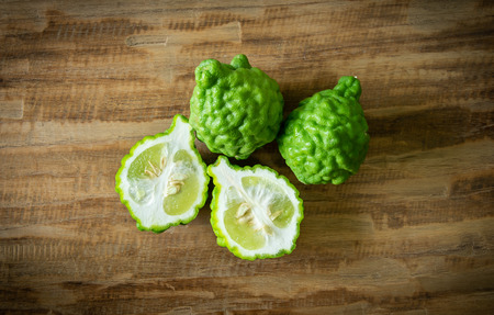 close up bergamot fruit and bergamot slice on wooden background.の写真素材