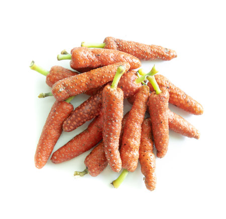 Fresh long pepper or Indian long pepper on white background, spices and herbsの写真素材