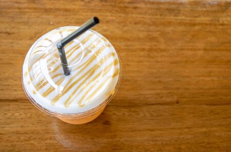 Iced tea with milk smoothies. Thai tea on wooden background with spaceの写真素材