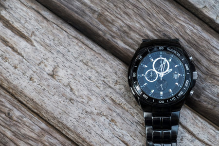 Old watch on wooden table