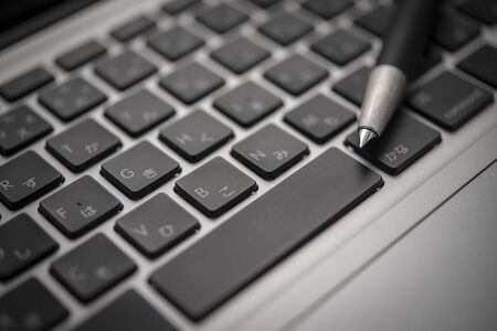 Close-up fountain pen on the keyboardの写真素材
