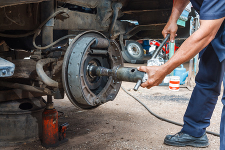 Professional car mechanic working in auto repair service.の写真素材