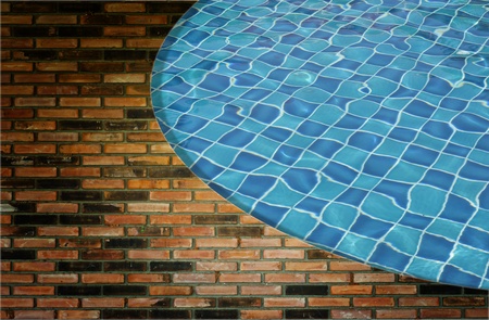 Blue wave water in Swimming pool and wall backgroundの写真素材