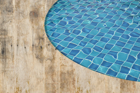 Background and pattern of clean water in blue swimming pool 