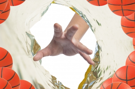 Hand catch basketball in plastic snack pack の写真素材