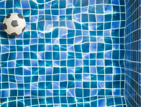Plasticine football and Blue water in Swimming poolの写真素材