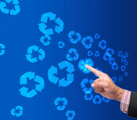 Hand pushing recycle button on a touch screen interface の写真素材