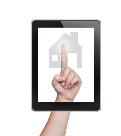 Hand pushing home button of tablet on a touch screenの写真素材