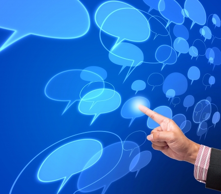 Hand pushing comment button on a touch screen interface の写真素材