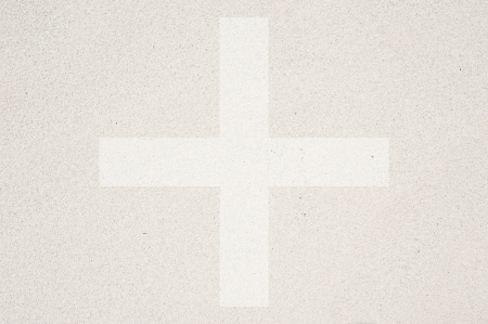 Plus icon on sand texture and background の写真素材