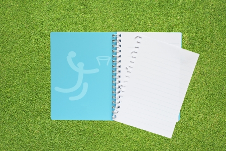 Book with Sport basketball icon on grass background の写真素材