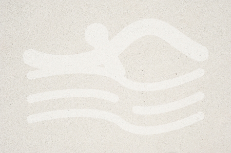Sport swimming icon on sand texture and background の写真素材