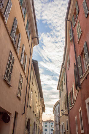 Traditional street or alley in Brescia, a italian north city at the sunset with blue clear sky and clouds in backgroundの写真素材