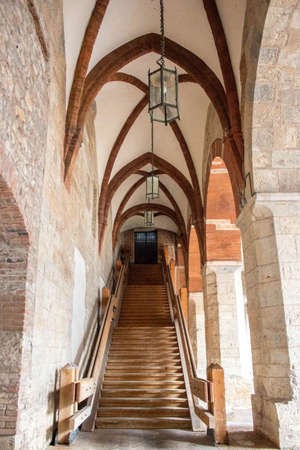 Medieval arch with stone bricks wall and columns in the center of Bresciaの写真素材