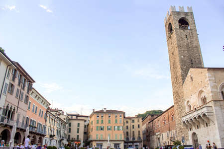 Brescia, Italy - 08 05 2018: Panoramic view of Paolo VI square in Brescia, Lombardy Region - Italy. Sunset scene with clear sky, a stone church tower on the right and bricks houses around the square.のeditorial素材