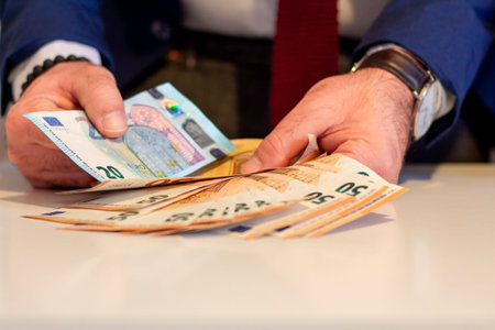 Business man showing in hand fifty euro banknote. Financial and money saving concept