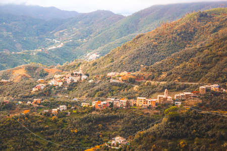 Scenic view of italian countryside village against autumn foliage during sunset, between Vernazza and Monterosso in cinque terre national park, liguria, Italyの写真素材