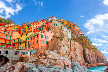 Manarola in cinque terre on the mountain near mediterranean sea in liguria - Italy. Sunny cloudy sky. Traditional italian architectureの写真素材