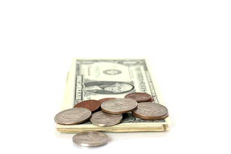 US cents lying on pack of US dollar banknotesの写真素材