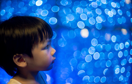 Asian boy with disco bokeh light backgroundの写真素材