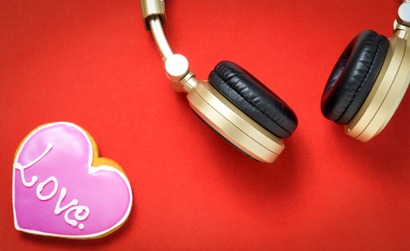 Love Heart on red background with Golden headphone.の写真素材