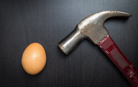 Hammering an Egg on black table.