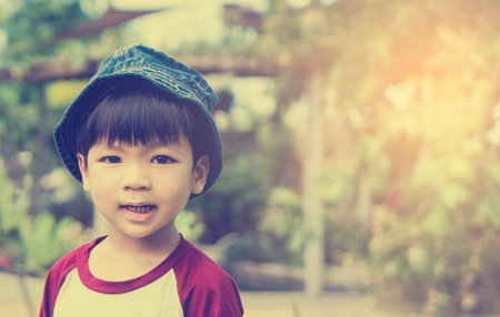 Japanese Baby boy with hat in summer garden.の写真素材