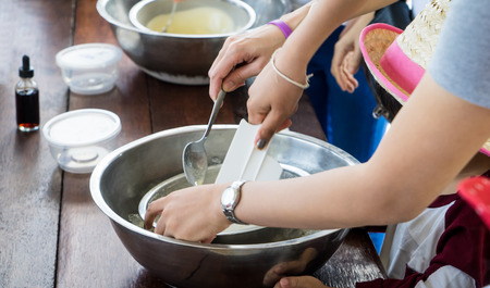 Children hand making home made ice cream cooking class. Spinning steel bowl for making Vanilla Ice Cream.の写真素材