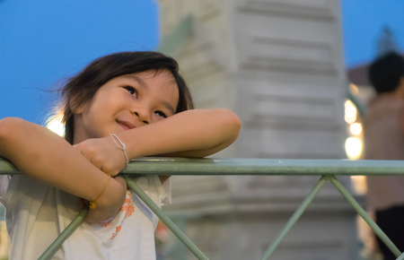 Happy Asian baby girl stand on the bridge.の写真素材