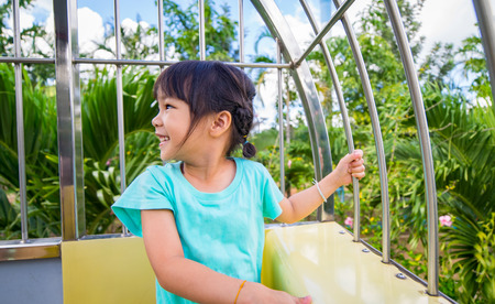 Asian Kid having fun on a Mountain Cable Carの写真素材