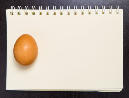 Raw Egg on a blank blinder note book.の写真素材