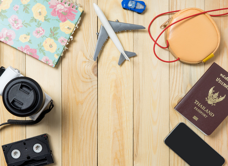 Travel Equipments on wooden board with copy space in the middle.の写真素材