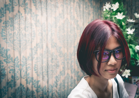 Asian nerdy girl on a vintage backgroundの写真素材