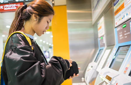 Fukuoka, Japan - March 20, 2016: Fukuoka on March 20, 2016. Tourist having a hard time buying Japan Subway ticket.のeditorial素材