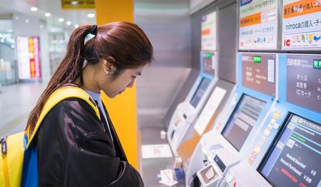 Fukuoka, Japan - March 20, 2016: Fukuoka on March 20, 2016. Tourist having a hard time buying Japan Subway ticket.のeditorial素材