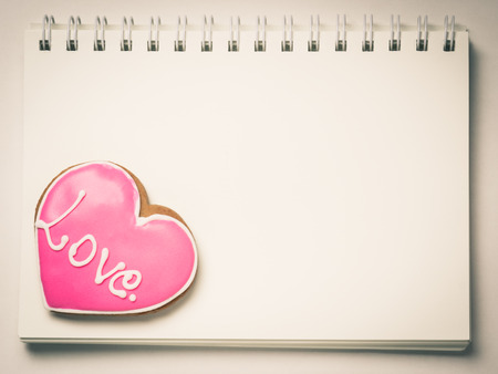 Love Heart Cookie shape on a blank book page.の写真素材