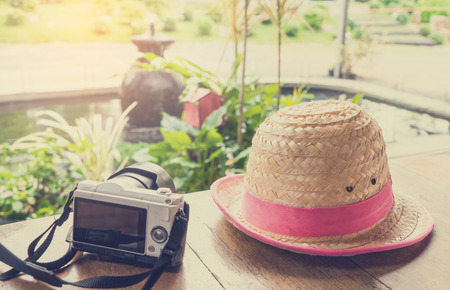 Mirrorless Camera on wooden table and a hatの写真素材