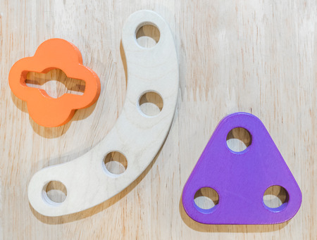Children wooden toy smiling robot on wooden background.の写真素材
