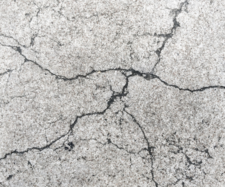 Cracked broken grunge concrete road floor wall gray color.の写真素材