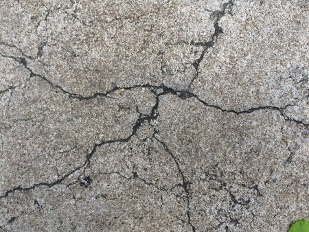 Cracked broken grunge concrete road floor wall gray color.の写真素材